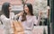 Two asian women doing window shopping together