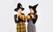 Two asian women in holloween costume with black witch hat holding the pumkin lantern on white background