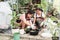 two asian women mixing plant material, soil and fertilizer, hobby and relaxation concept
