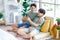 Two Asian young handsome pride male gay men lover couple partner sitting smiling together on cozy sofa in bedroom holding looking