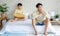 Two Asian young upset unhappy stressed depressed sad teenager male gay men lover couple partner sitting in different corners on