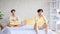 Two Asian young upset unhappy stressed depressed sad teenager male gay men lover couple partner sitting in different corners on