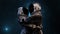 Two astronauts couple in space suits embracing against a backdrop of distant stars and the cosmic expanse. Love huge, man and