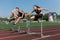 Two athlete woman and man runnner running hurdles