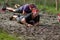 Two athletes crawling through mud in a 10km Obstacle Race.