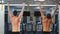 Two athletes doing pull-up on horizontal bar in the gym