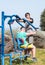 Two athletes perform exercises on outdoor public exercise machines in the open air in Zefat city in Israel