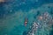 Two athletic man floats on a red boat in river