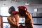 Two athletic and muscular body boxer with safety helmet on boxing match. Impetus