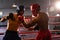 Two athletic and muscular body boxer with safety helmet on boxing match. Impetus