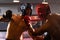 Two athletic and muscular body boxer with safety helmet on boxing match. Impetus