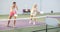 Two athletic women of different ages are playing a game of pickleball on a court inside sports facility