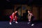 Two Attractive fit women athlete performing a kettle-bell swing in gym