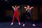 Two Attractive fit women athlete performing a kettle-bell swing in gym