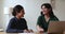 Two attractive friendly women colleagues talking in office at workplace