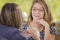 Two Attractive Teen Mixed Race Girlfriends Talking Over Drinks Outside