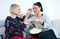 Two attractive woman friends with popcorn talking