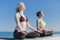 Two attractive young women meditating on open air