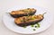 Two Aubergines Stuffed with Cheese and Mushrooms