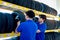 Two auto mechanic Asian man checking wheel tires at vehicle repair service shop together, men working in garage, car service