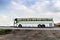 Two axle, rear engine, air-conditioned luxury bus , speeding on a highway in Pune, Maharashtra, India.