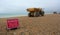 Two B 40D Articulated dump trucks & warning sign on beach.