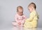 two babies talking on white background