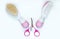 Two baby combs and pink baby scissors