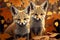 Two baby foxes sitting in fall leaves