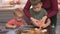 two baby sibling brothers learning to decorate halloween cookies with mother