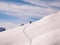 Two backcountry skiers climbing a mountain in the Swiss Alps after a fresh snow fall