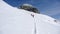 Two backcountry skiers hiking to a far away mountain peak in the Austrian Alps in winter