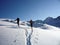 Two backcountry skiers on a tour in the Austrian Alps and putting in new tracks on their way to the summit