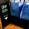 Two Bags Of Takeaway Caffe Nero Food And Drink Waiting To Be Collected By Uber Eats