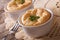Two baked cheese souffle in a white pot close-up. horizontal
