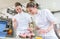 Two baker women in pastry bakery working on muffins