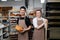 Two bakers, male and female posing for a photo in a bakery kitchen