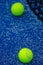two ball on a blue paddle tennis court