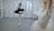 The two ballerinas are exercising the dance for performance in bright studio.