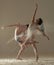 Two ballet dancers perform dance against background of white flour cloud in air