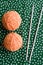 Two balls of yarn and knitting needles orange crochet