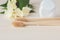 Two bamboo toothbrushes, dental floss and white flowers, close-up