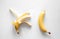 Two bananas on a white background isolated, conceptual minimalism.