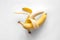 Two bananas on a white background isolated, conceptual minimalism.