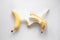 Two bananas on a white background isolated, conceptual minimalism.