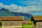 Two barns on a meadow in front of a detached house in the Bavarian mountains