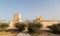 Two Barzan watchtowers fortifications behind desert bushes, Qatar. Middle East. Persian Gulf.