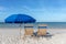 Two Beach Chairs and Umbrella on Beach