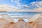 Two beachchairs on the sand near sea and colorful sky