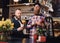 Two bearded hipster coffee shop owners at the counter.